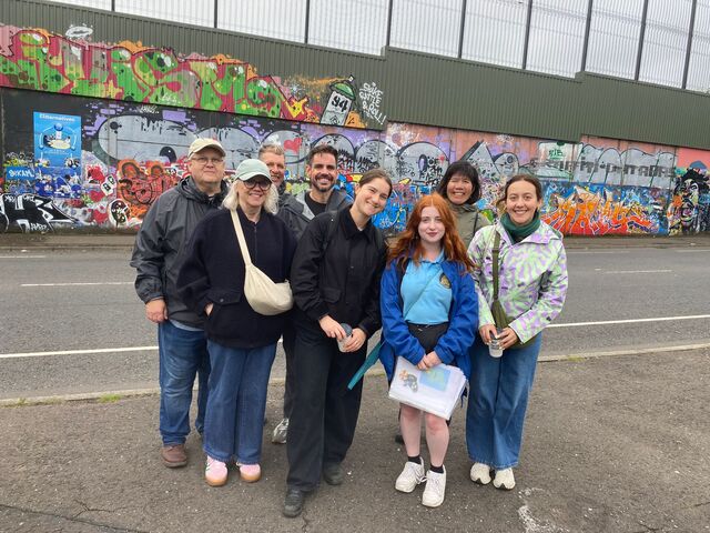 Visitors signing the Peace Wall in Belfast